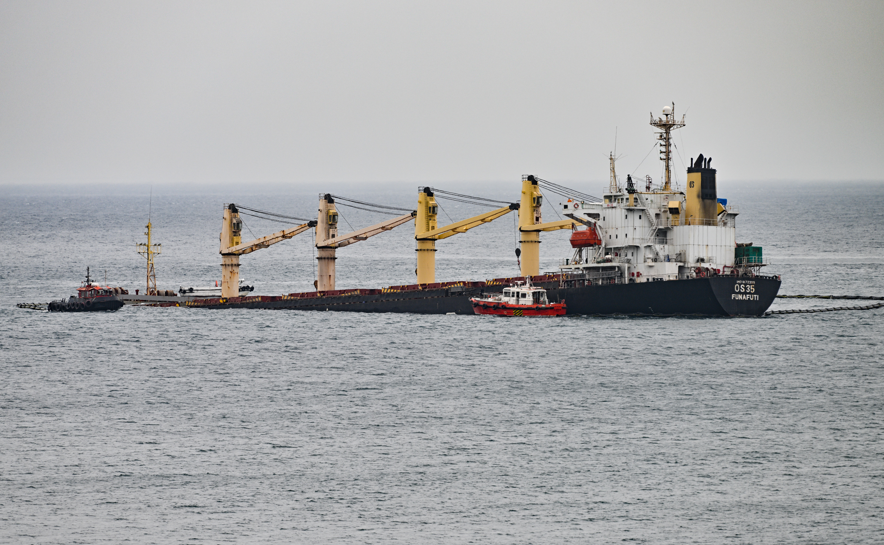 Resolve Marine rescue crafts alongside partially sunken bulk carrier OS-35.